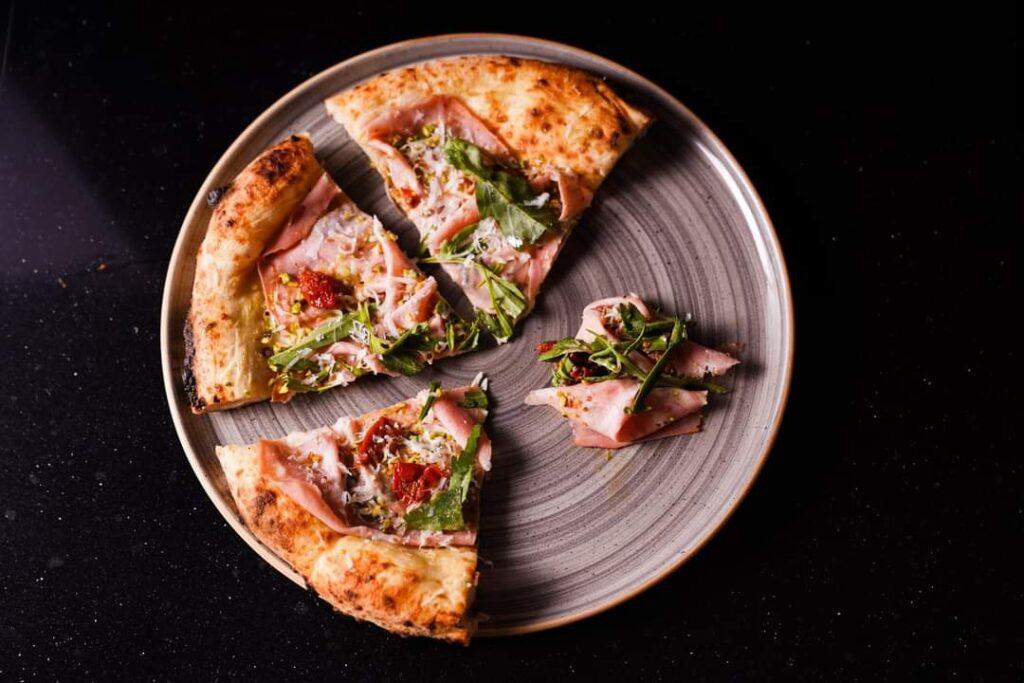 Fior di latte Montrone, Pesto al pistacchio di Bronte, Mortadella BBS, pomodoro fiaschetto semi dry di Torre Guaceto, Parmigiano Reggiano vacche rosse, Olio al limone Guglielmi, Granella di pistacchio di Bronte